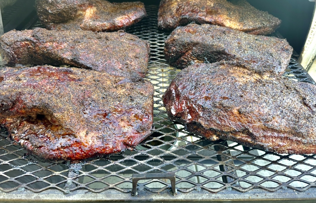 Beautifully barked briskets on the smoker grates