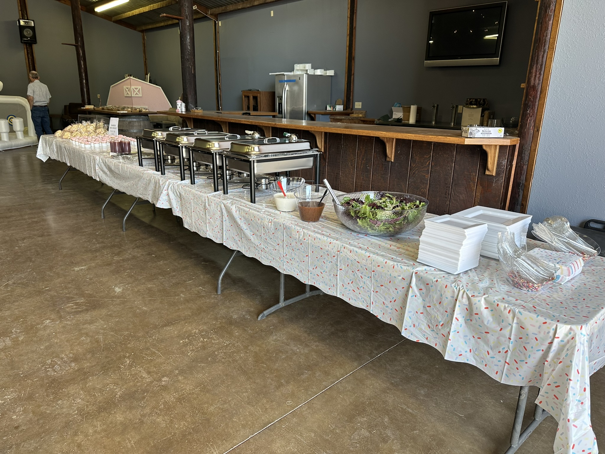 Professional catering buffet line setup in a rustic hall